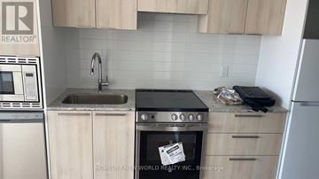 Toronto (Church-Yonge Corridor) condo for rent - A kitchen with a stove top oven and a dishwasher.