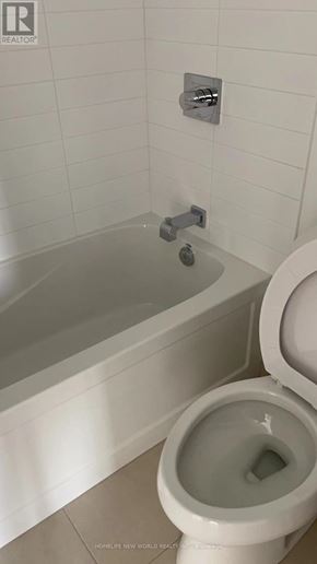 Toronto (Church-Yonge Corridor) condo for rent - A white toilet with a white bathtub in the background.