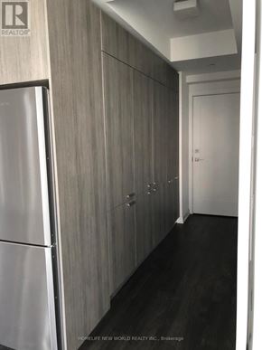 Toronto (Church-Yonge Corridor) condo for rent - A long hallway with wood paneling and a white door.