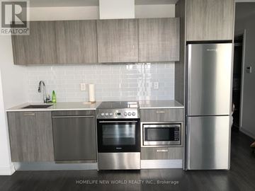 Toronto (Church-Yonge Corridor) condo for rent - A modern kitchen with stainless steel appliances and wooden cabinets.