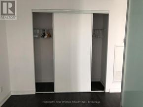 Toronto (Church-Yonge Corridor) condo for rent - A white closet with a glass door is in the middle of a room.