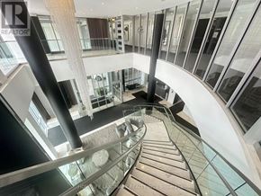 Richmond Hill (Observatory) condo for rent - A staircase with a glass railing and a metal pole.