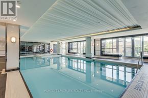 Richmond Hill (Observatory) condo for rent - A swimming pool inside a building with a ceiling that has a slanted design.