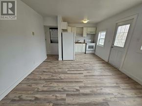 St. John's multi-family for rent - A kitchen with a refrigerator, oven, and microwave.