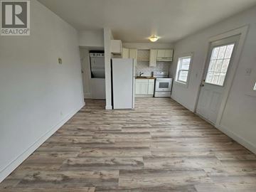 St. John's multi-family for rent - A kitchen with a refrigerator, oven, and microwave.