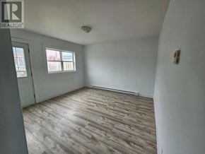 St. John's multi-family for rent - A room with wooden flooring and a window.