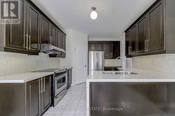Richmond Hill (Jefferson) apartment for rent - A kitchen with dark brown cabinets and stainless steel appliances.