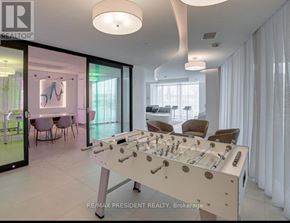 Burlington (Alton) condo for rent - A foosball table in a well-lit room with a dining area in the background.