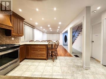 Toronto (Rockcliffe-Smythe) apartment for rent - A kitchen with wooden cabinets and a tile floor.