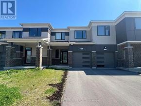Ottawa townhouse for rent - A modern two-story residential building with a driveway in front.