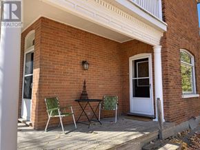 Blue Mountains multi-family for rent - A patio with a table and chairs is on a brick house.