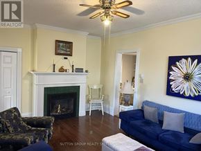 Blue Mountains multi-family for rent - A living room with a fireplace and a painting on the wall.