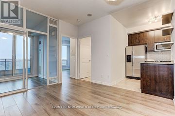 Toronto (Willowdale East) condo for rent - A spacious kitchen with wooden cabinets and a refrigerator.