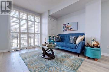 Milton (De Dempsey) townhouse for rent - A blue couch sits in a living room with a coffee table in front of it.