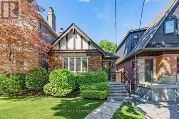 Toronto (Forest Hill North) apartment for rent - A house with a green lawn and a tree with orange leaves.