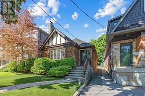 Toronto (Forest Hill North) apartment for rent - A house with a green lawn and a tree with orange leaves.