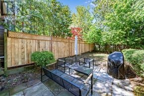 Toronto (Forest Hill North) apartment for rent - A backyard with a wooden fence and a bench.