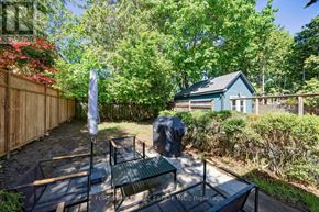 Toronto (Forest Hill North) apartment for rent - A backyard with a table and chairs and a blue house in the background.
