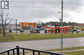 Waterloo apartment for rent - A view of a street with a Zehrs store and a REALTOR sign.