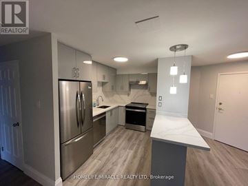 Mississauga (City Centre) condo for rent - A kitchen with a refrigerator, sink, and countertop.