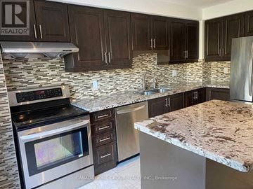 Mississauga (Erin Mills) apartment for rent - A kitchen with granite countertops and stainless steel appliances.