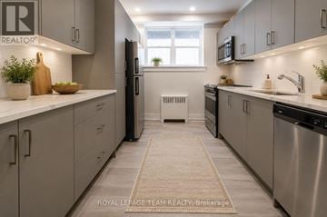Ottawa apartment for rent - A well-lit, modern kitchen with stainless steel appliances and light grey cabinets.