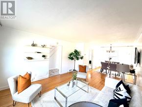 Toronto (Wexford-Maryvale) apartment for rent - A living room with a grey couch, a glass coffee table, and a white wall.