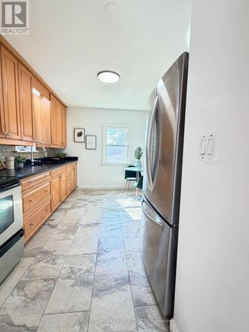 Toronto (Wexford-Maryvale) apartment for rent - A kitchen with a refrigerator on the right side.