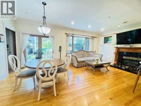 Vancouver apartment for rent - A living room with a fireplace and a dining table with chairs.