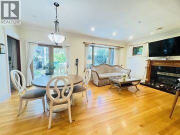 Vancouver apartment for rent - A living room with a fireplace and a dining table with chairs.