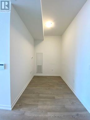 Richmond Hill (South Richvale) condo for rent - A long, narrow hallway with wood flooring and white walls.