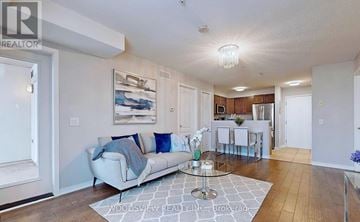 Brampton (Goreway Drive Corridor) condo for rent - A living room with a white couch and a painting on the wall.