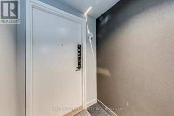 Mississauga (City Centre) condo for rent - A spacious kitchen with black cabinets and a stainless steel oven.