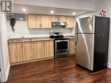 Mississauga (Churchill Meadows) apartment for rent - A kitchen with wooden cabinets and a stainless steel refrigerator.
