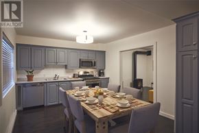St. John’S apartment for rent - A dining room with a table set for a meal.