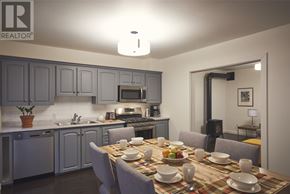 St. John’S apartment for rent - A modern kitchen with a dining table set for a meal.