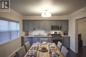 St. John’S apartment for rent - A dining room with a table set for a meal.