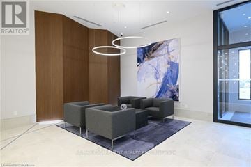 Grimsby (Grimsby Beach) house for rent - A modern living room with a grey sofa set and a large abstract painting on the wall.