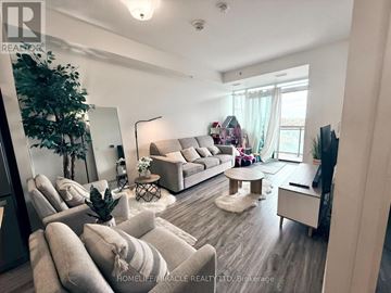Waterloo condo for rent - A living room with a grey couch and a white coffee table.