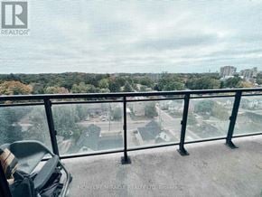 Waterloo condo for rent - A balcony with a view of a residential area.