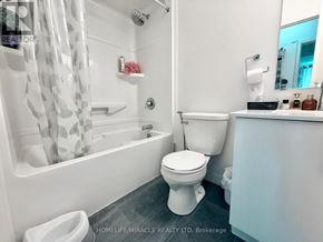 Waterloo condo for rent - A white bathroom with a toilet, sink, and bathtub.