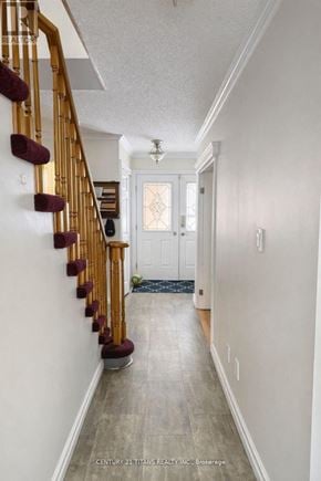 Whitby (Pringle Creek) apartment for rent - A hallway with a staircase and a door.