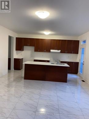 Newmarket (Glenway Estates) apartment for rent - A kitchen with white marble flooring and brown cabinets.