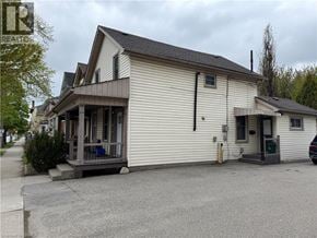 Brantford apartment for rent - A two-story house with a white exterior and a brown roof.