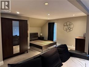 Brantford apartment for rent - A bedroom with a bed, a chair, and a cabinet.