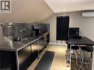 Brantford apartment for rent - A kitchen with a black countertop and stainless steel appliances.