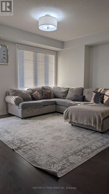 Whitby (Brooklin) townhouse for rent - A grey couch with pillows and a grey blanket in a living room.