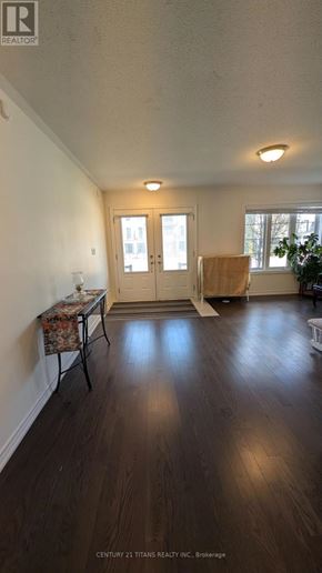 Whitby (Brooklin) townhouse for rent - A room with wooden floors and a table with a floral tablecloth.