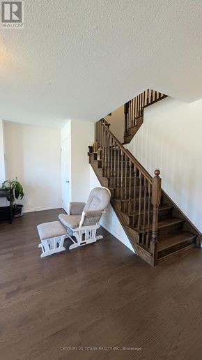 Whitby (Brooklin) townhouse for rent - A living room with a staircase and a chair.