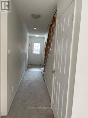 Toronto (Clairlea-Birchmount) townhouse for rent - A long hallway with a door at the end.
